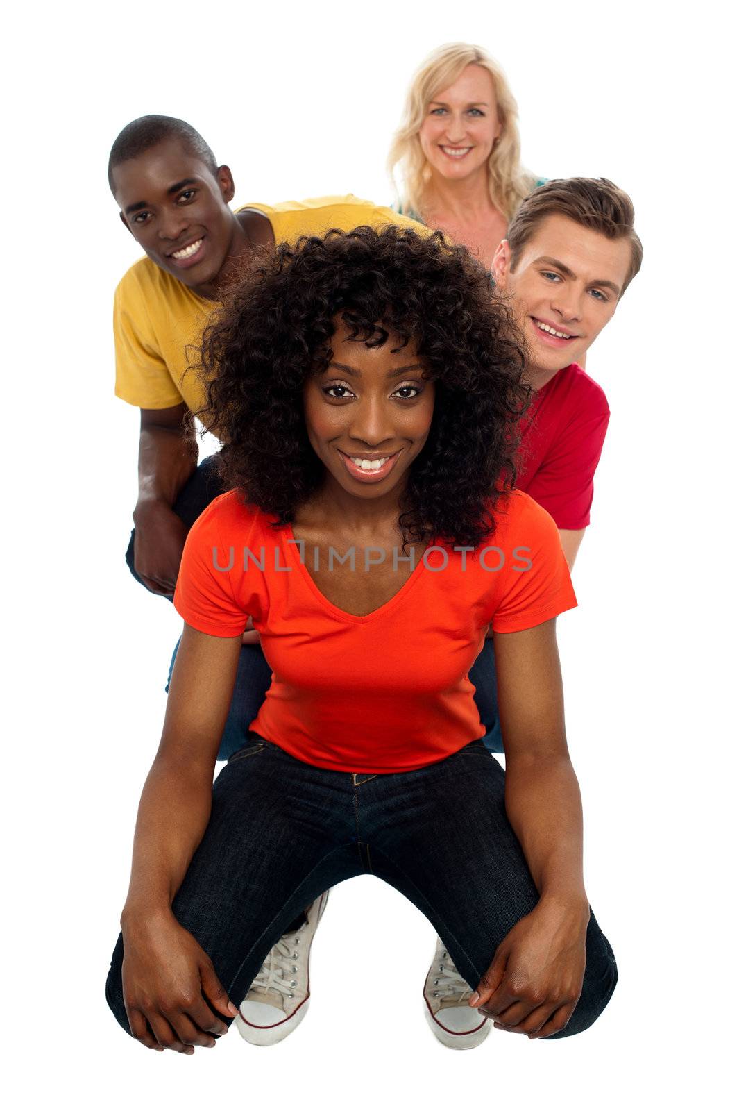 Line of teens with behind ones peeping out. Indoor studio shot