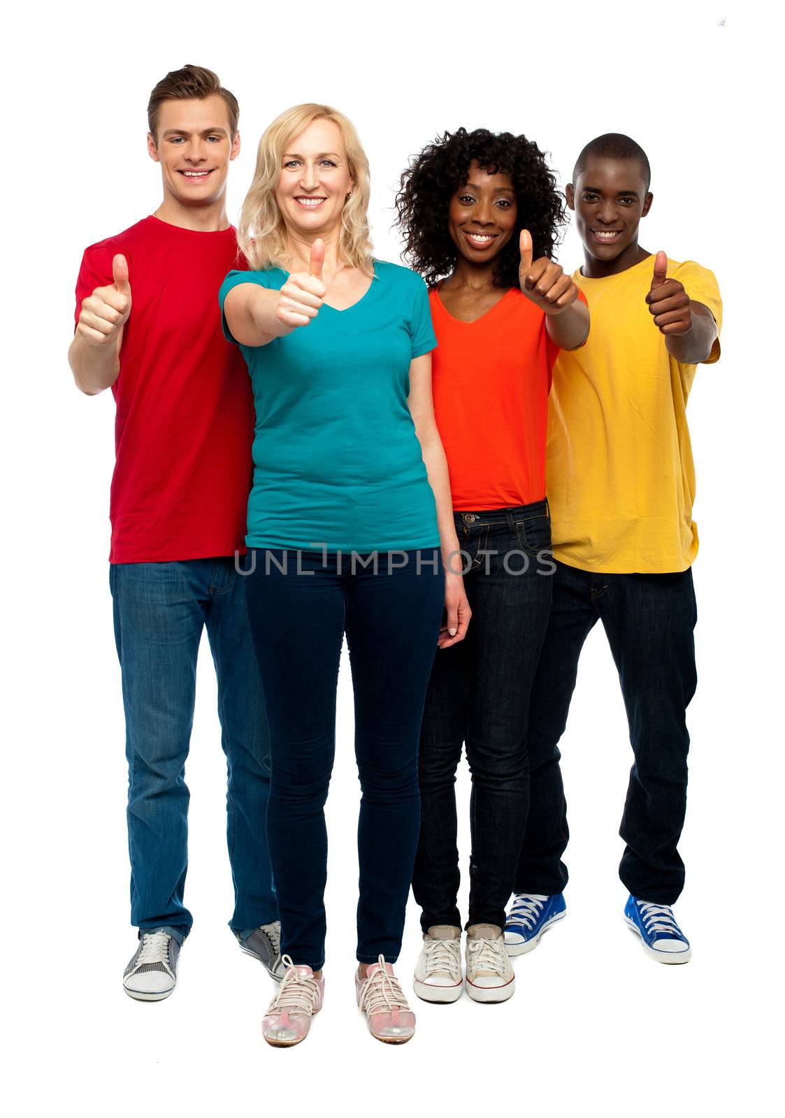 Happy young teens gesturing thumbs up by stockyimages