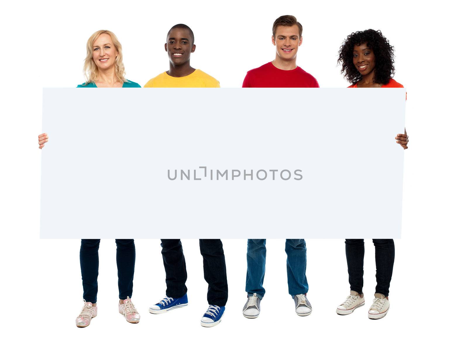 Confident young group showing blank poster, full length portrait