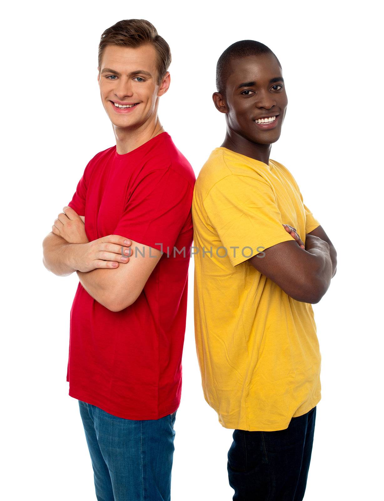 Friends posing back to back with arms crossed isolated on white