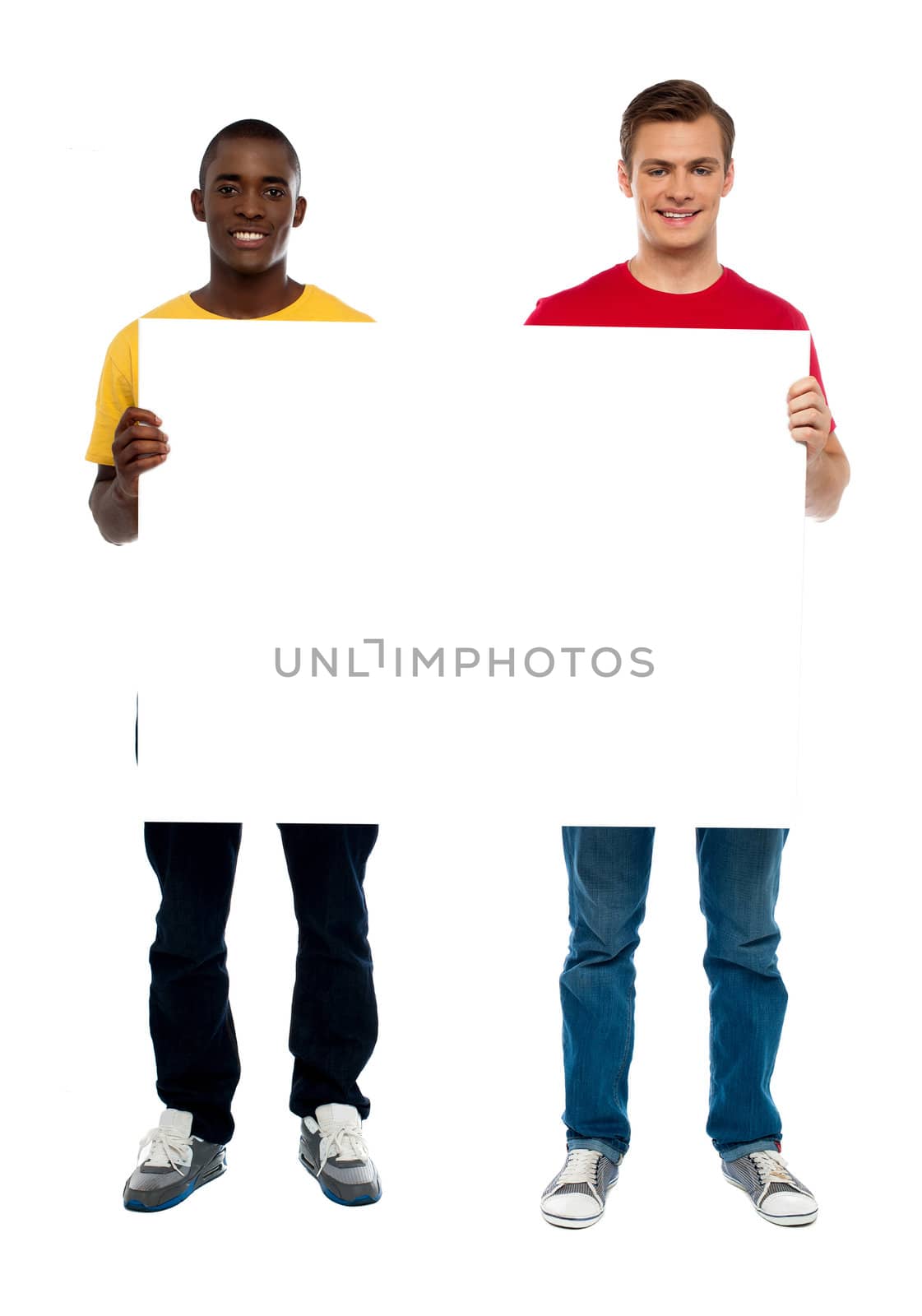 Trendy young guys presenting blank banner ad by stockyimages