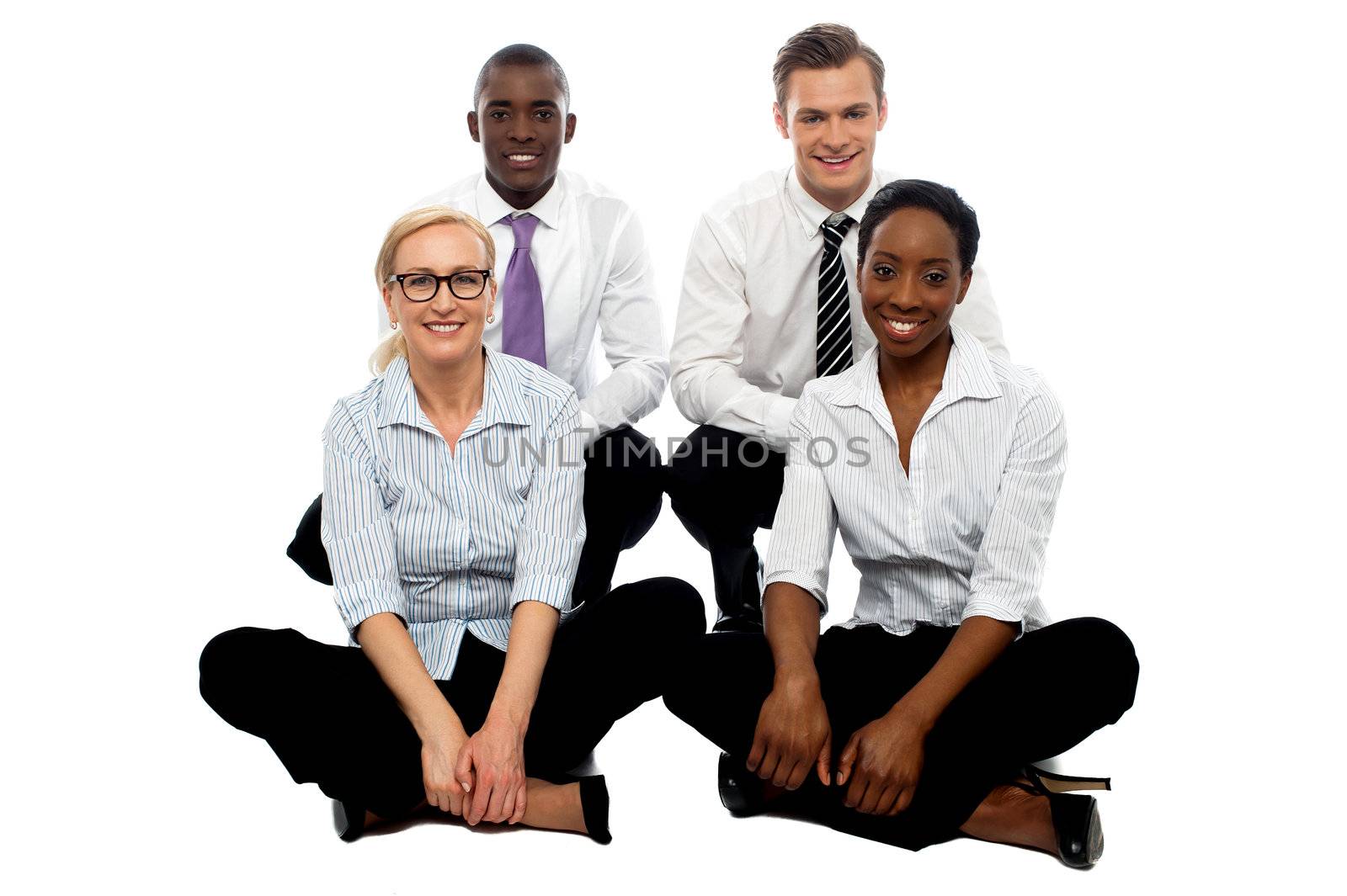 Four business colleagues sitting on floor by stockyimages