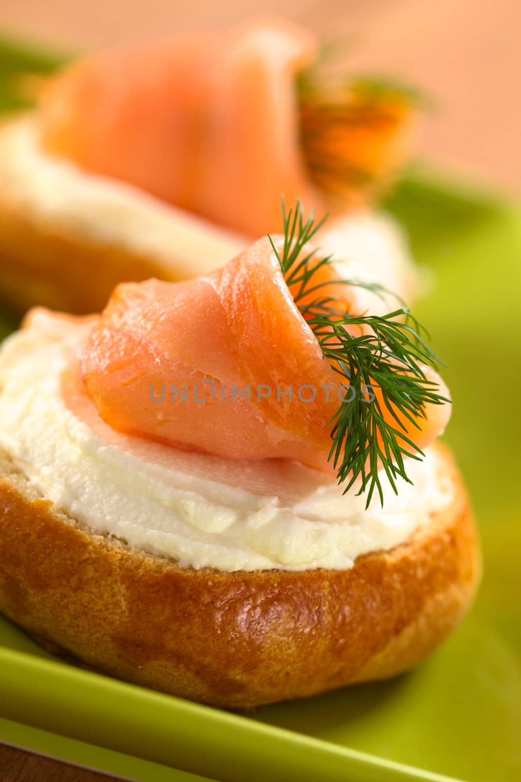 Smoked salmon and cream cheese canapes garnished with dill (Selective Focus, Focus on the front of the salmon)