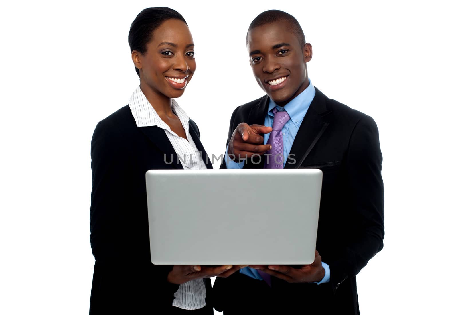 African coworkers operating laptop and pointing by stockyimages