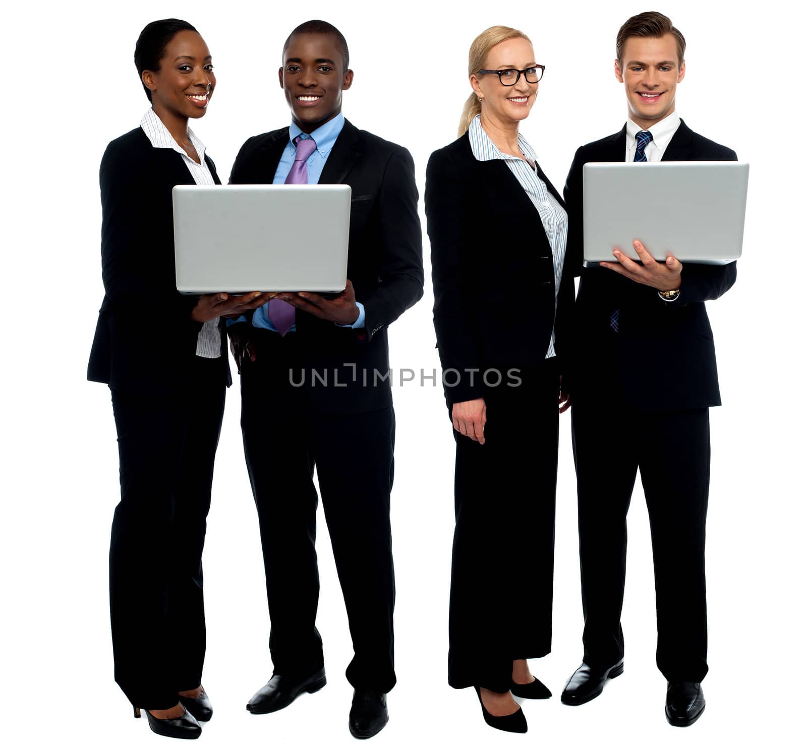 Two business teams posing with laptop by stockyimages