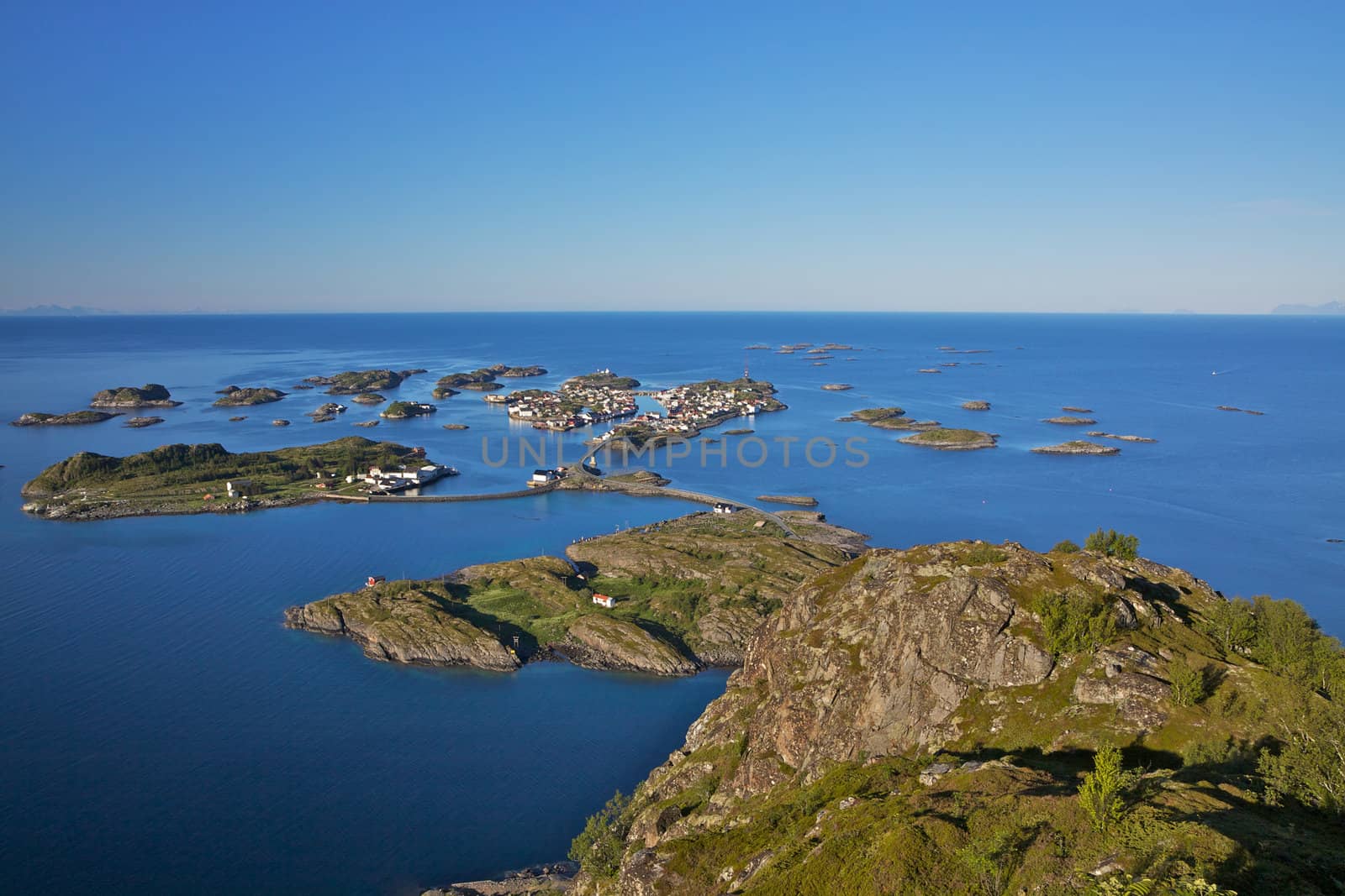 Scenic town of Henningsvaer on Lofoten islands in Norway with large fishing harbour and bridges connecting rocky islands