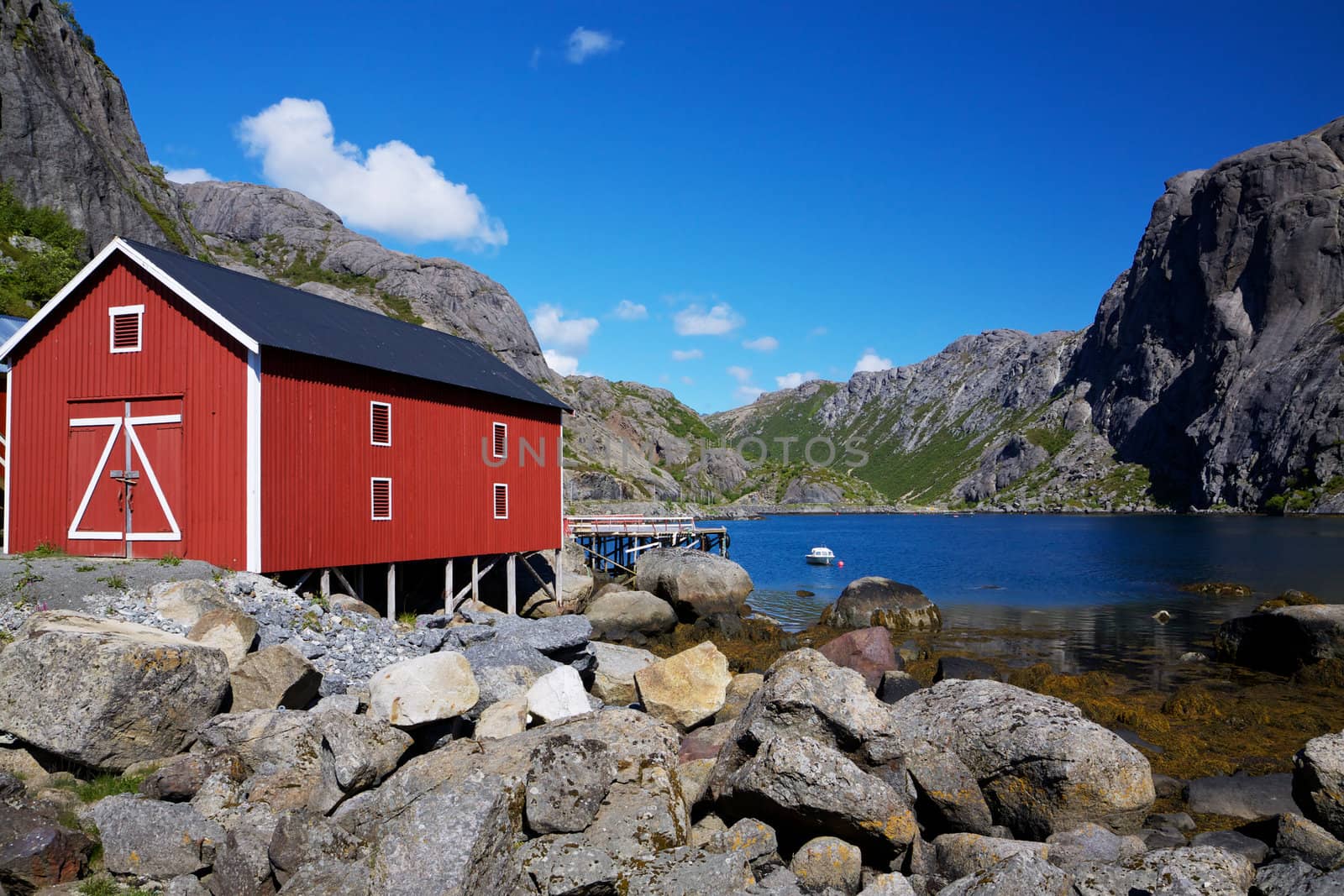 Typical red shed on the coast of fjord on Lofoten islands in Norway