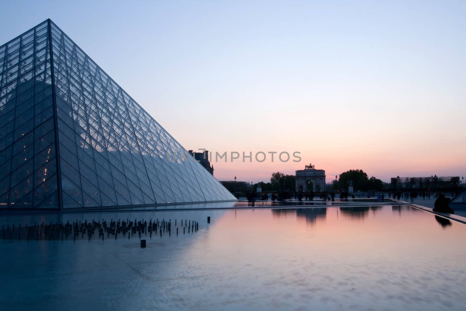 PARIS - APRIL 16: Louvre Pyramid at dusk during the Summer Exhibition April 16, 2010 in Paris. Louvre is the biggest Museum in Paris displayed over 60,000 square meters of exhibition space.