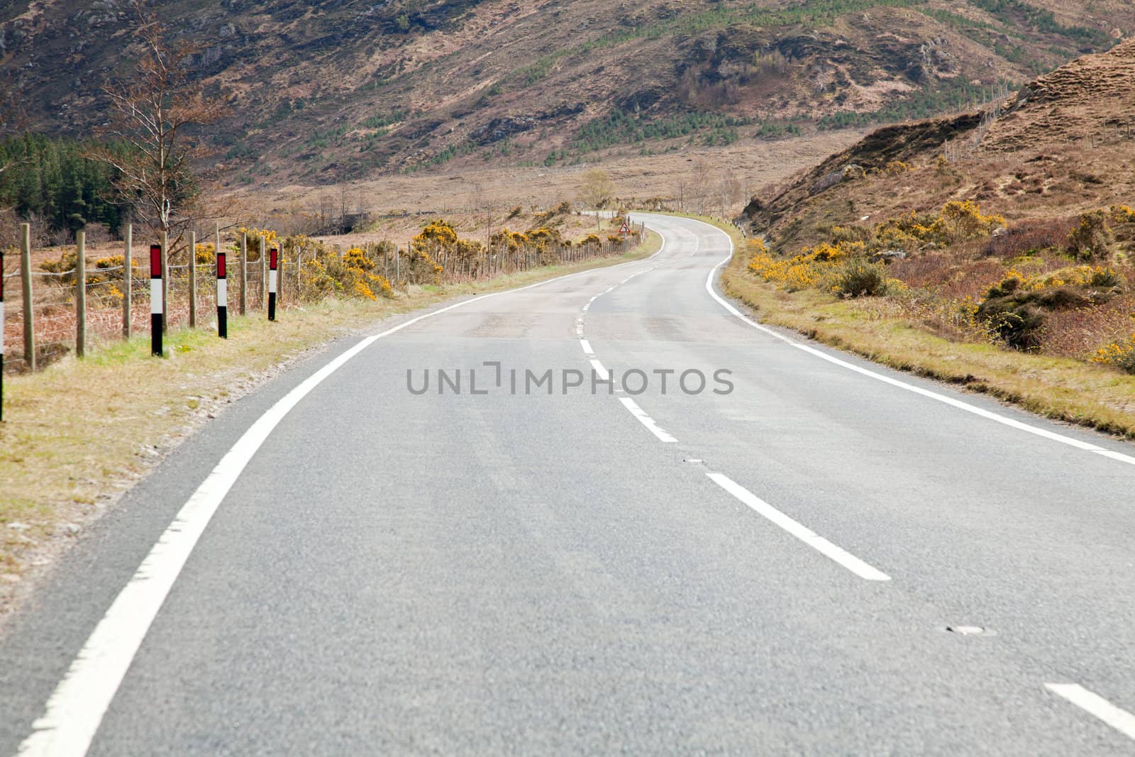 Empty road stretching out into the distance Highlands Scotland UK