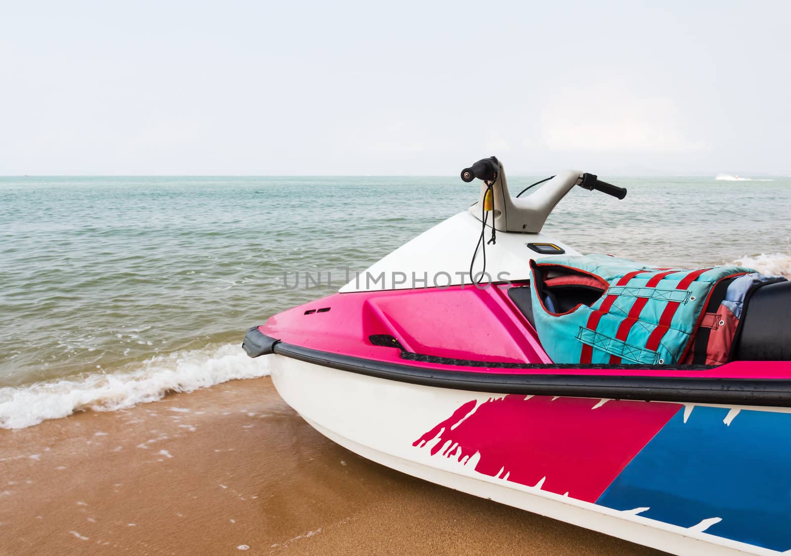 Pink  jet ski close up parked on the beach