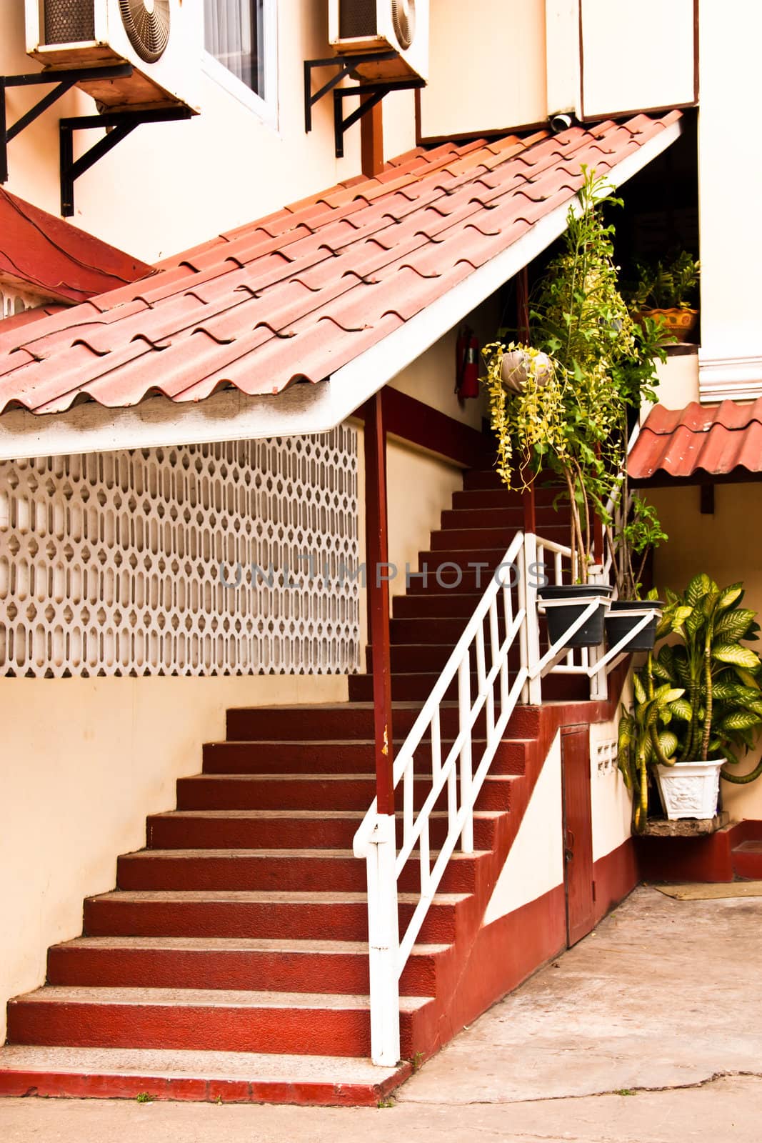 The stairs up to the house. Stairs are on the side of the house.