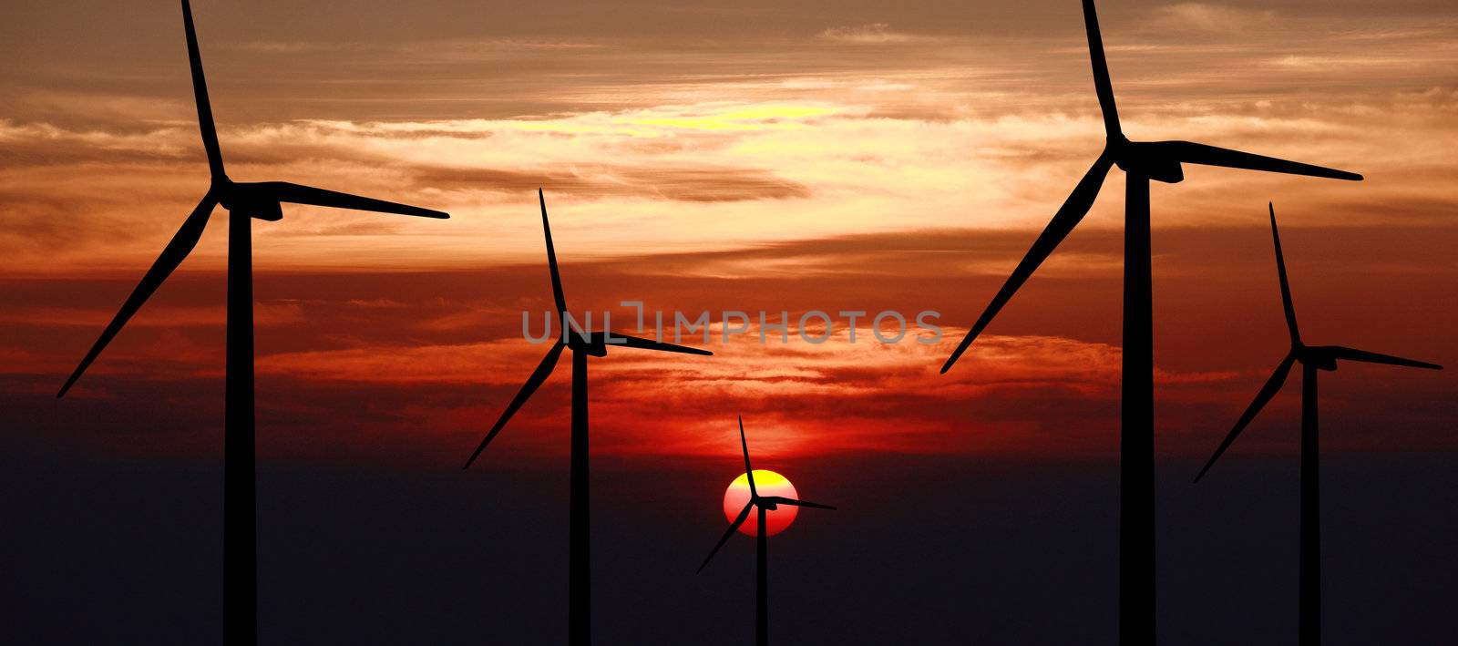 wind turbine generator with sunset on background