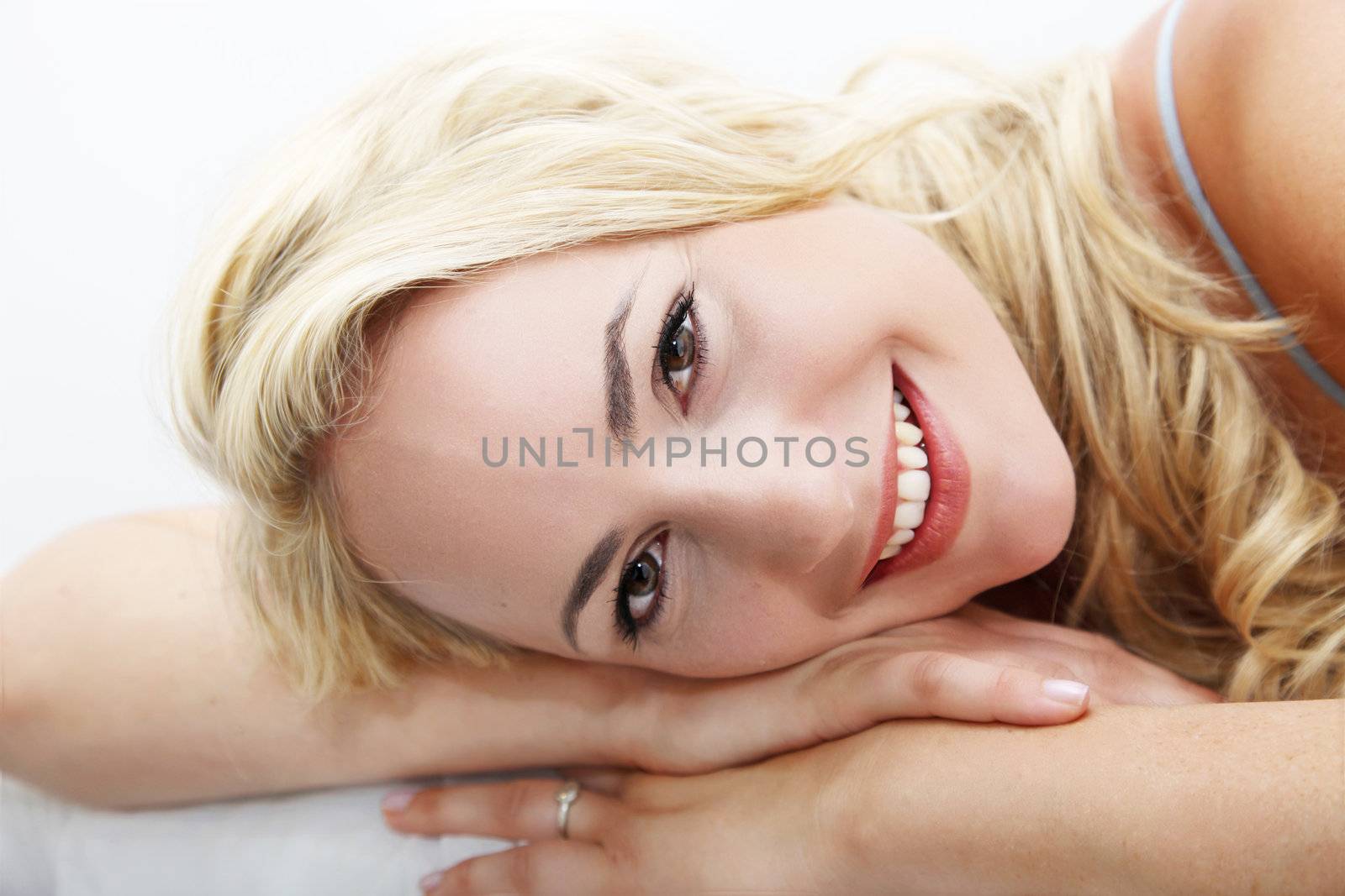 Happy woman lying with head on arms  by Farina6000