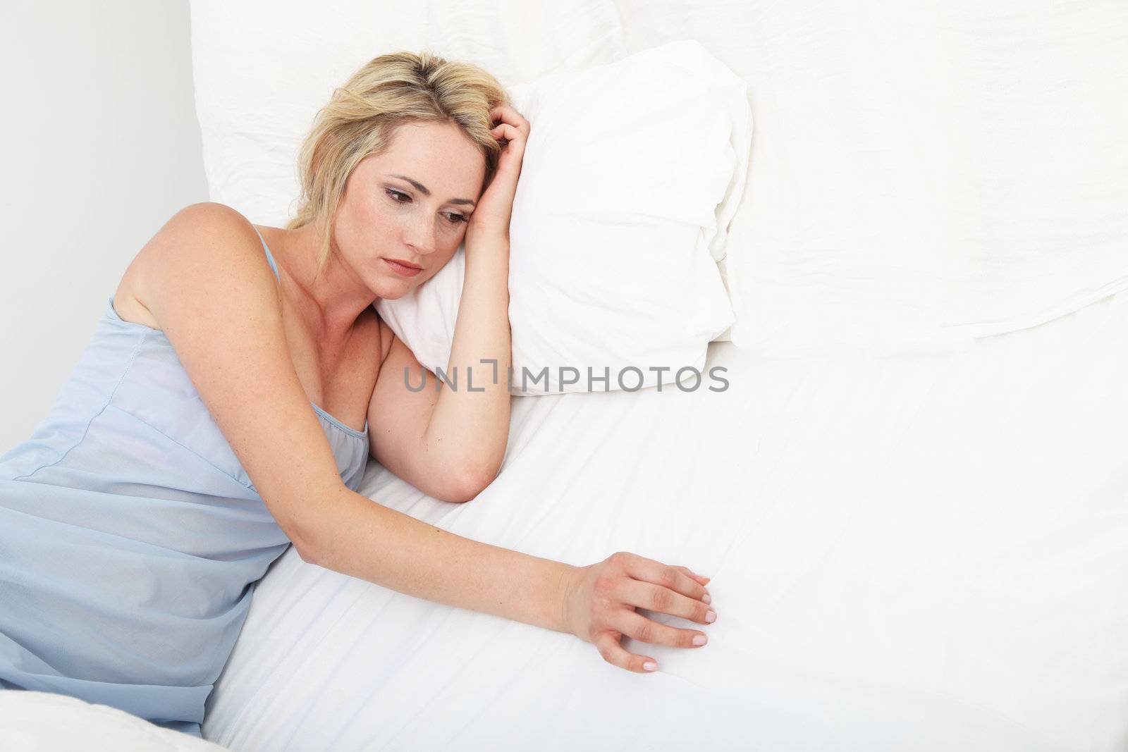 Sick depressed woman propped up on pillows  by Farina6000