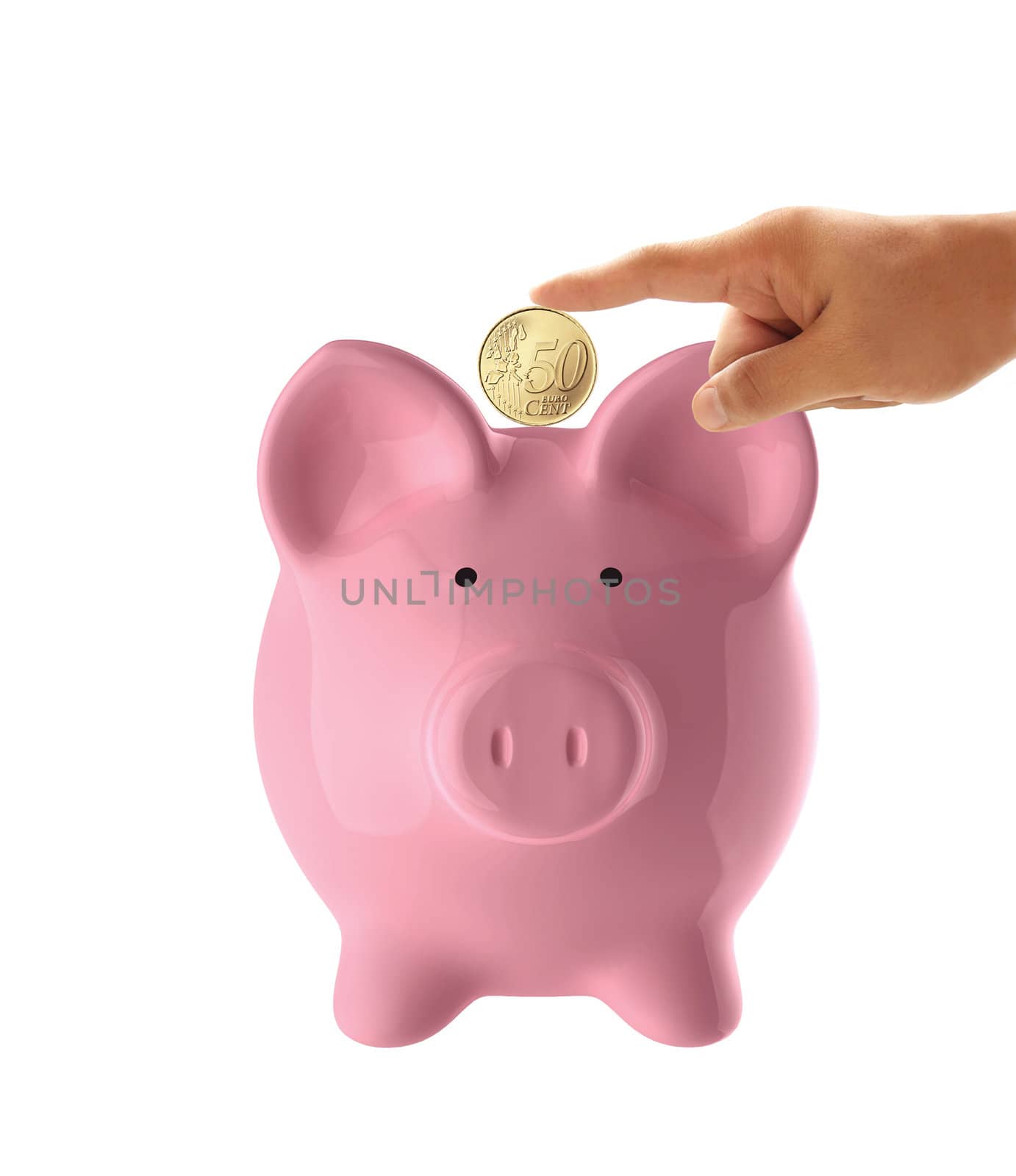 Hand putting coin into the pink piggy bank