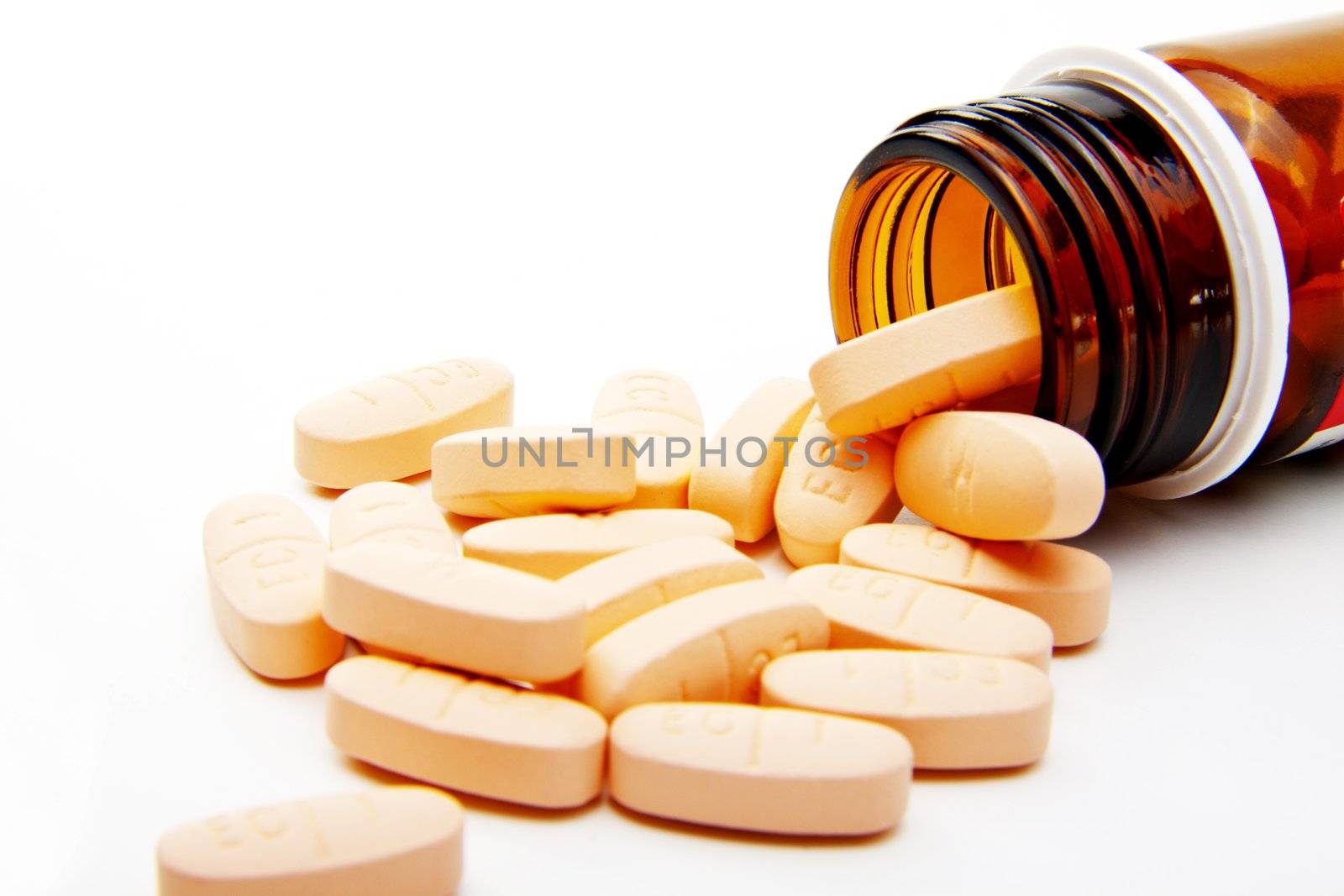 Pills from bottle on the white background