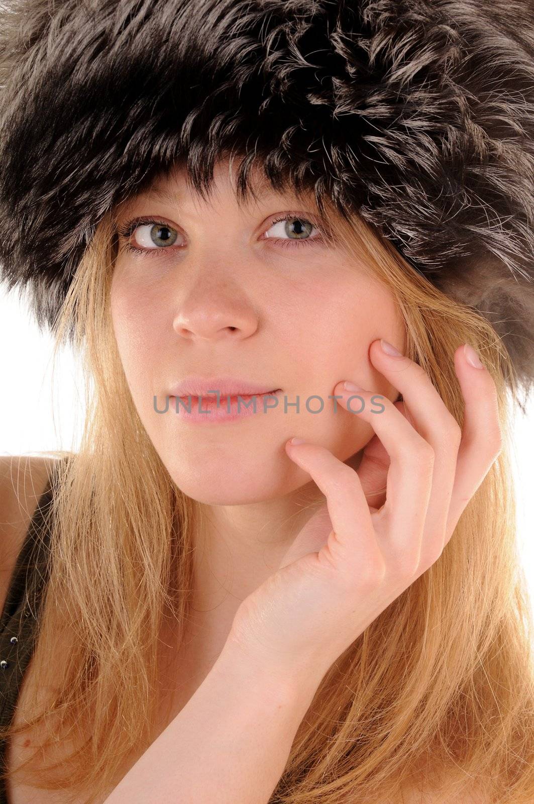 Blonde nice girl in fur hat.