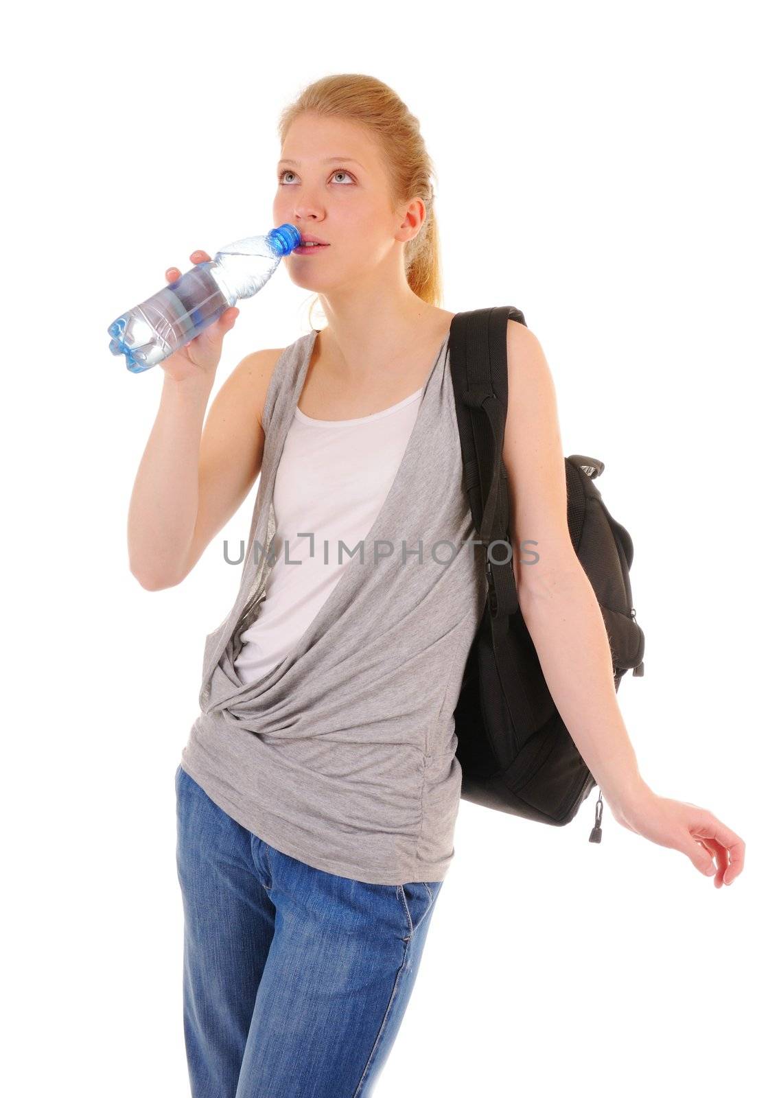 Nice girl in casual style is drinking clear water from plastic bottle isolated on white background