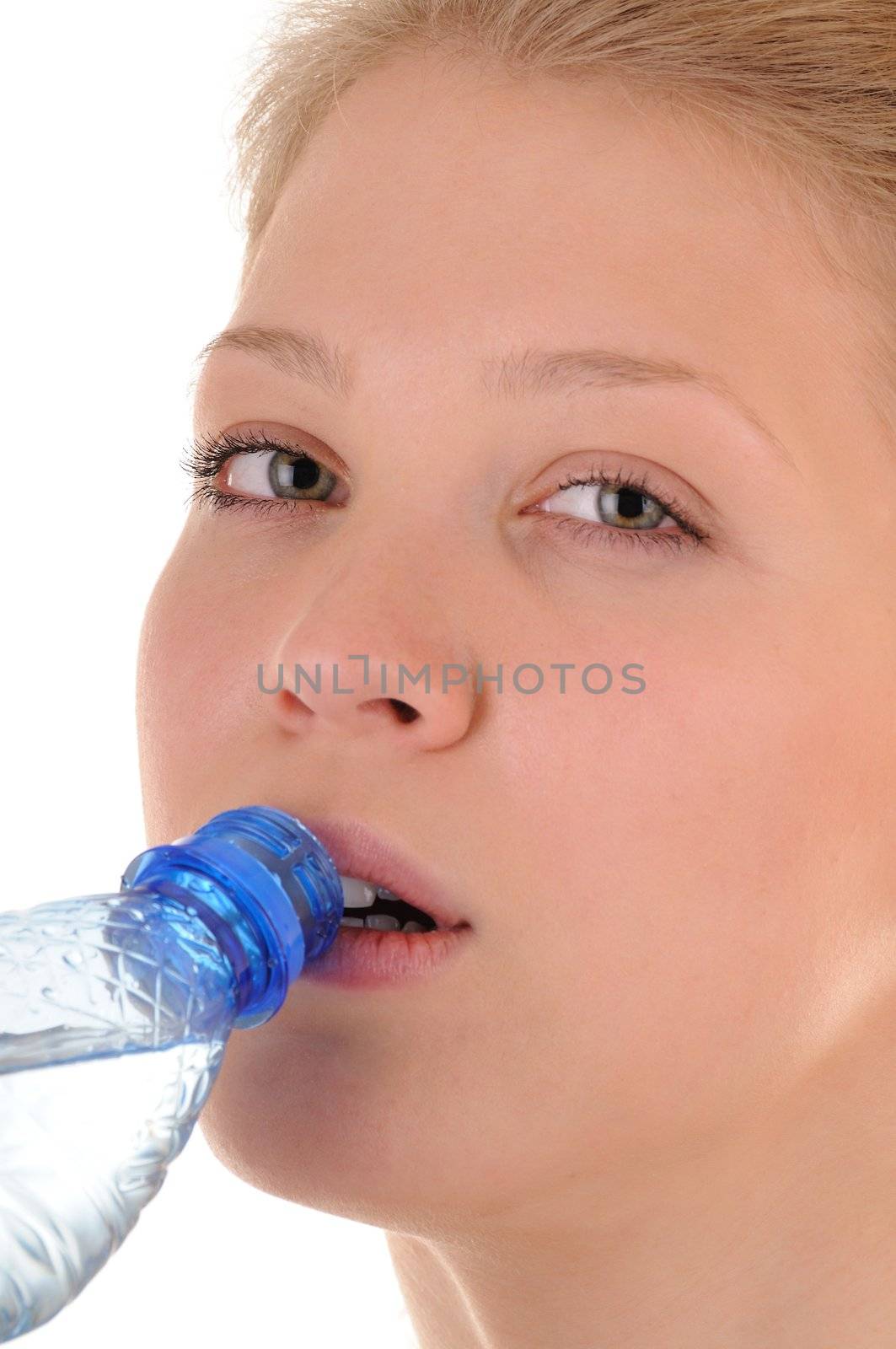 Nice girl is drinking clear water from plastic bottle