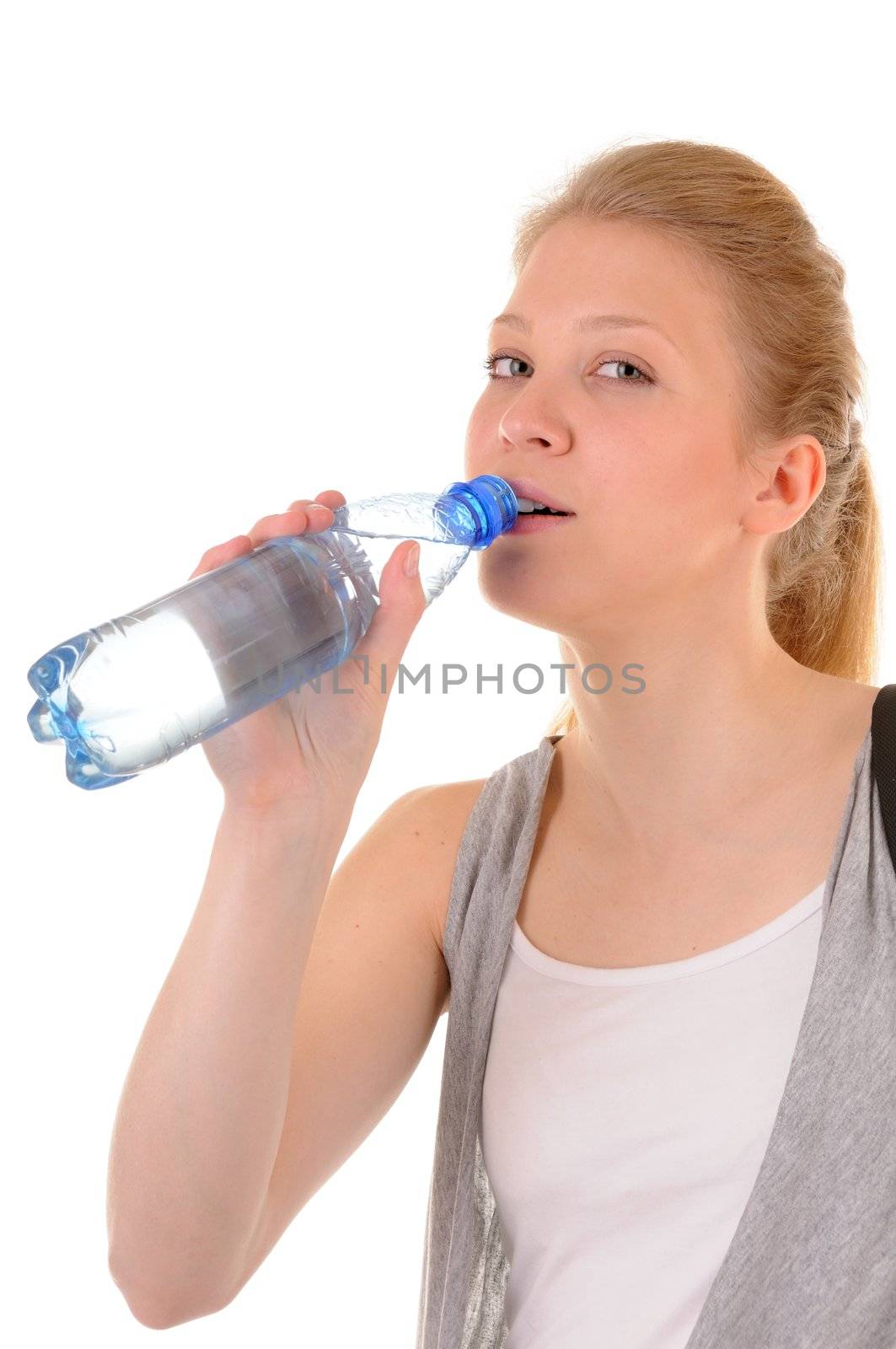 Nice girl in casual style is drinking clear water from plastic bottle