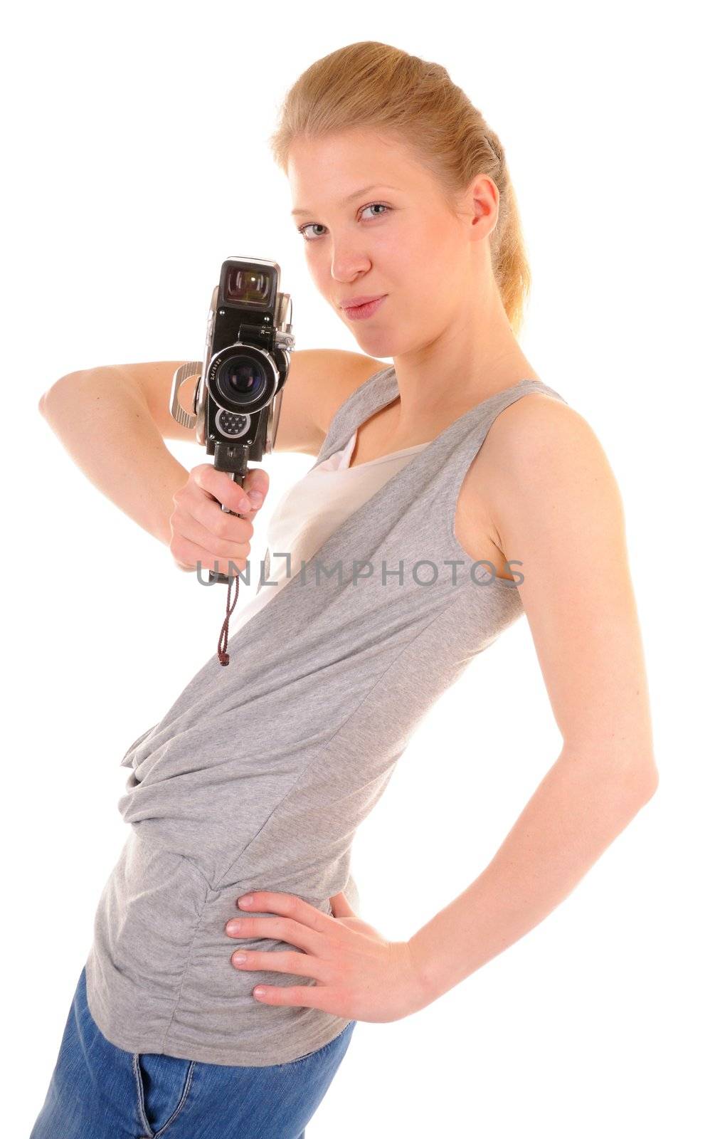 Beauty girl is shooting a film by old video camera. On white background.