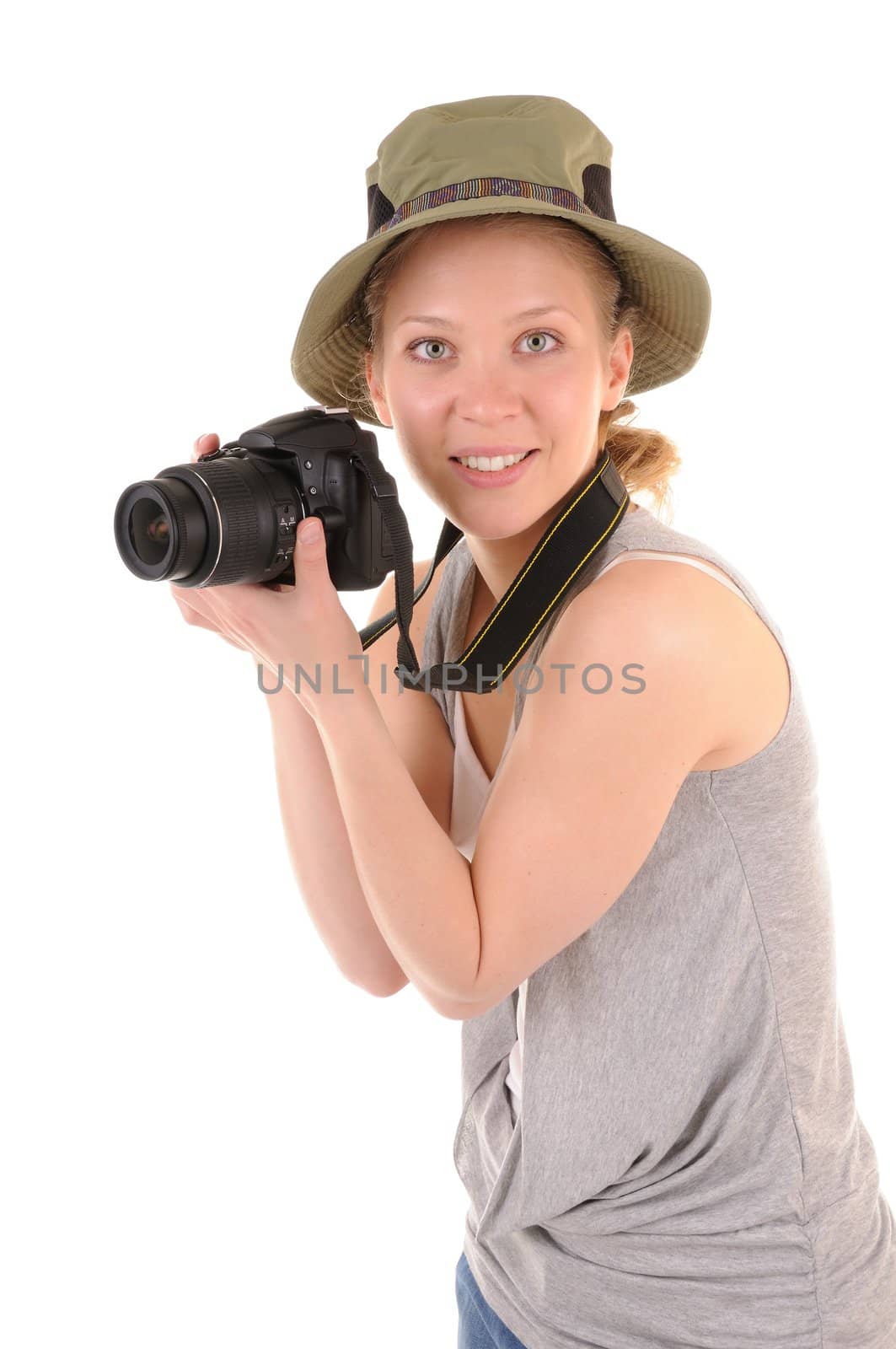 Casual smiling girl-tourist with digital photocamera is looking for picture on white background