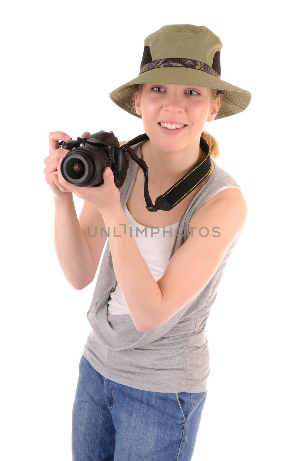 Casual smiling girl-tourist with digital photocamera is looking for picture on white background