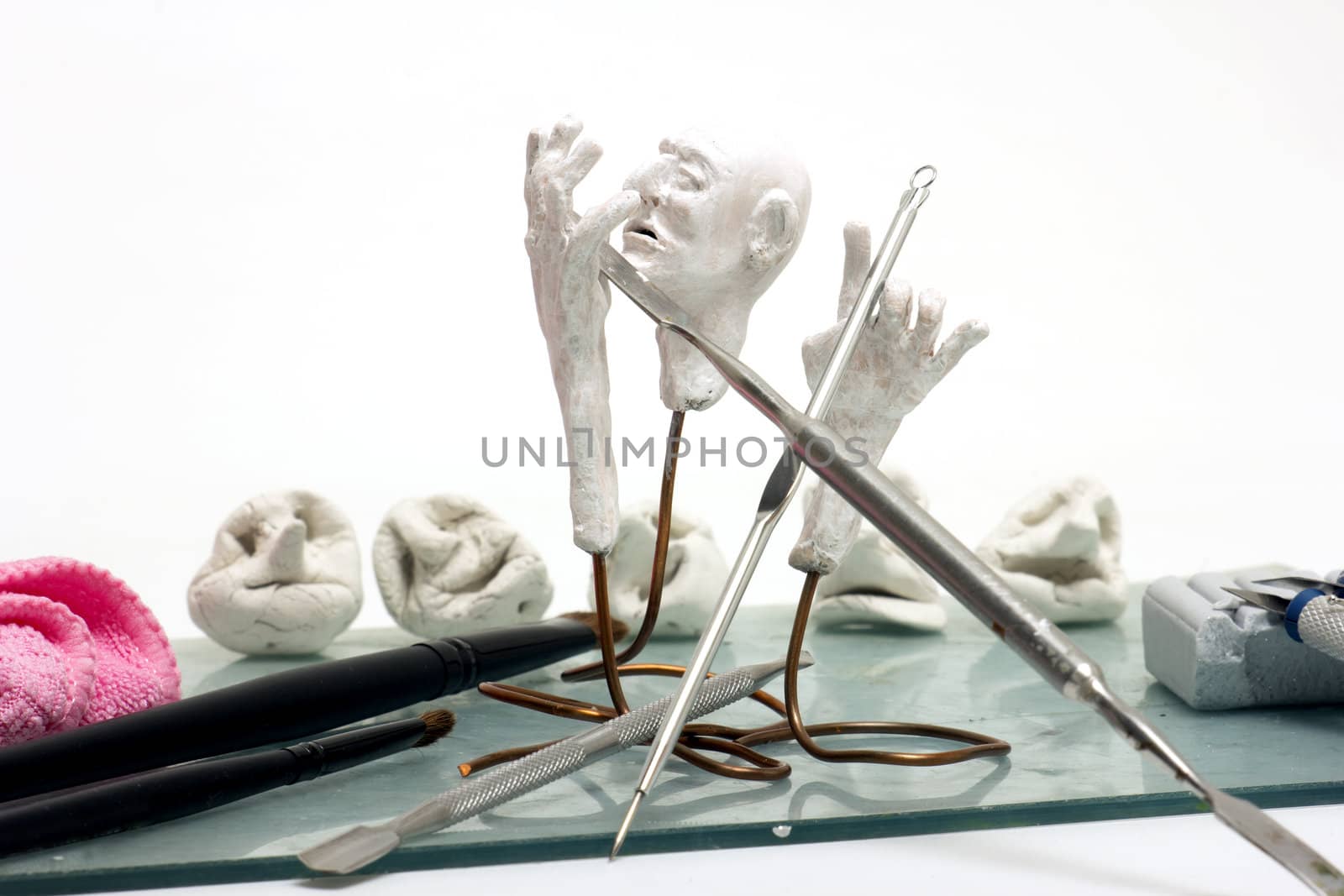 Workplace sculptor miniaturist. Working with polymer clay.