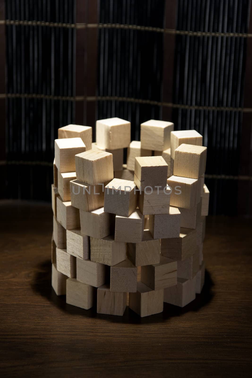 Tower of wooden blocks, built on a wooden surface