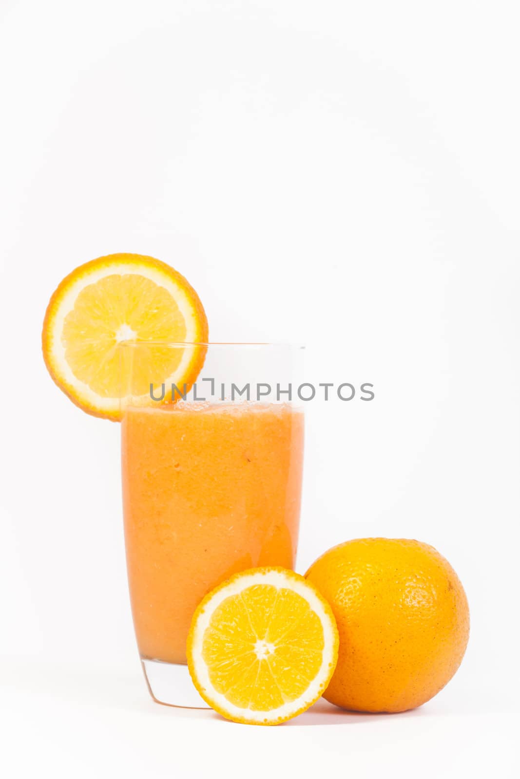 A delicious glass of natural orange juice isolated on a white background.