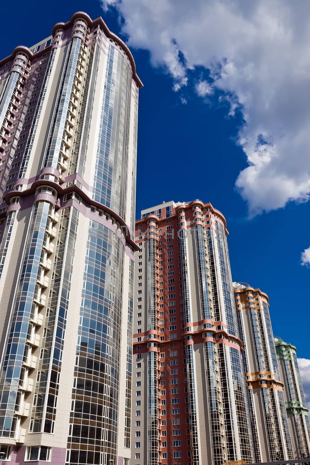 High modern apartment buildings under blue sky
