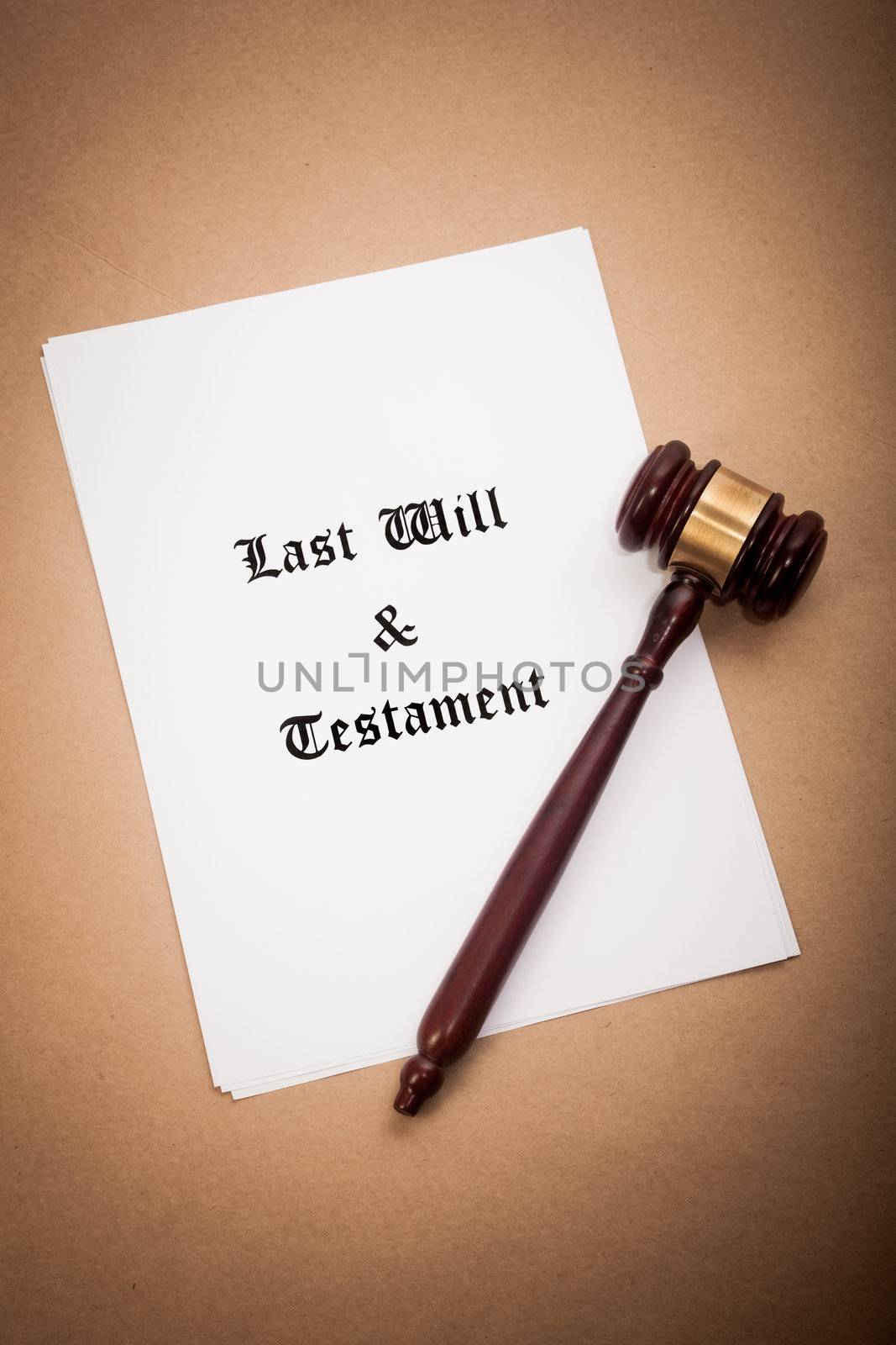 A gavel on top of a "Last Will and Testament" contract, with a antique-like background.