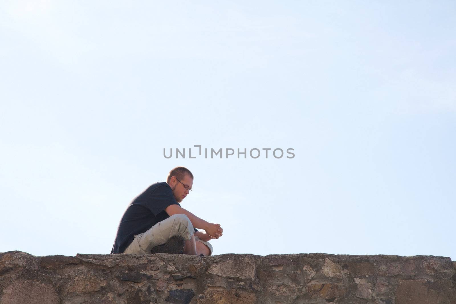 Young man sitting outdoors