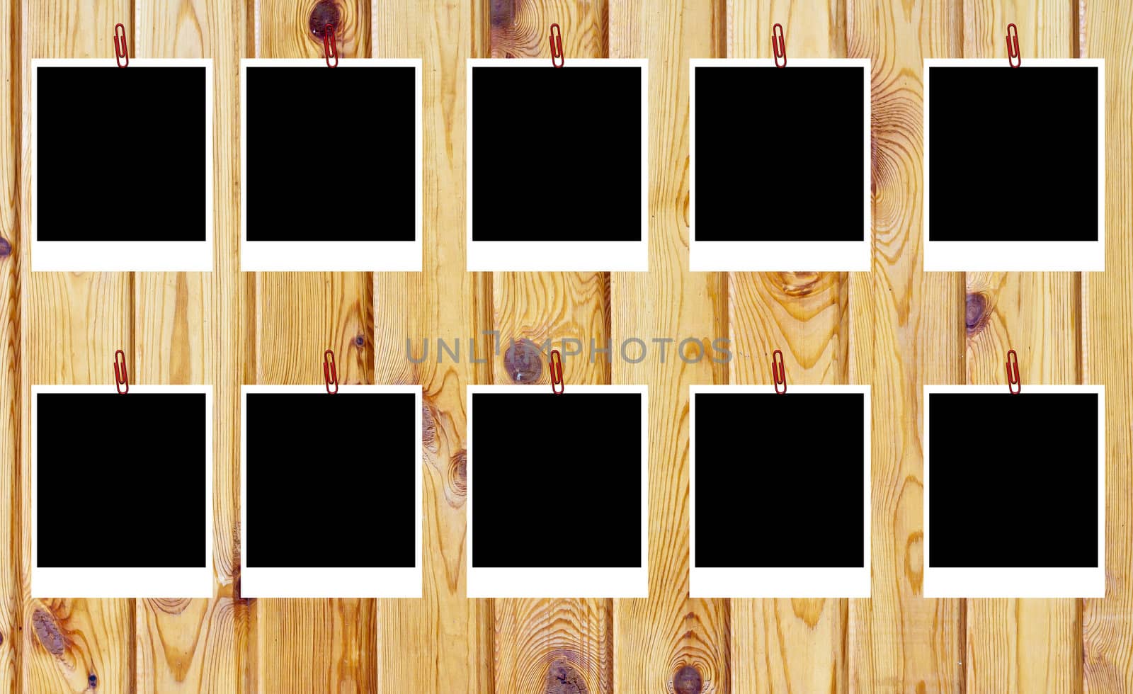 set of ten old blank polaroids frames lying on a wood surface 