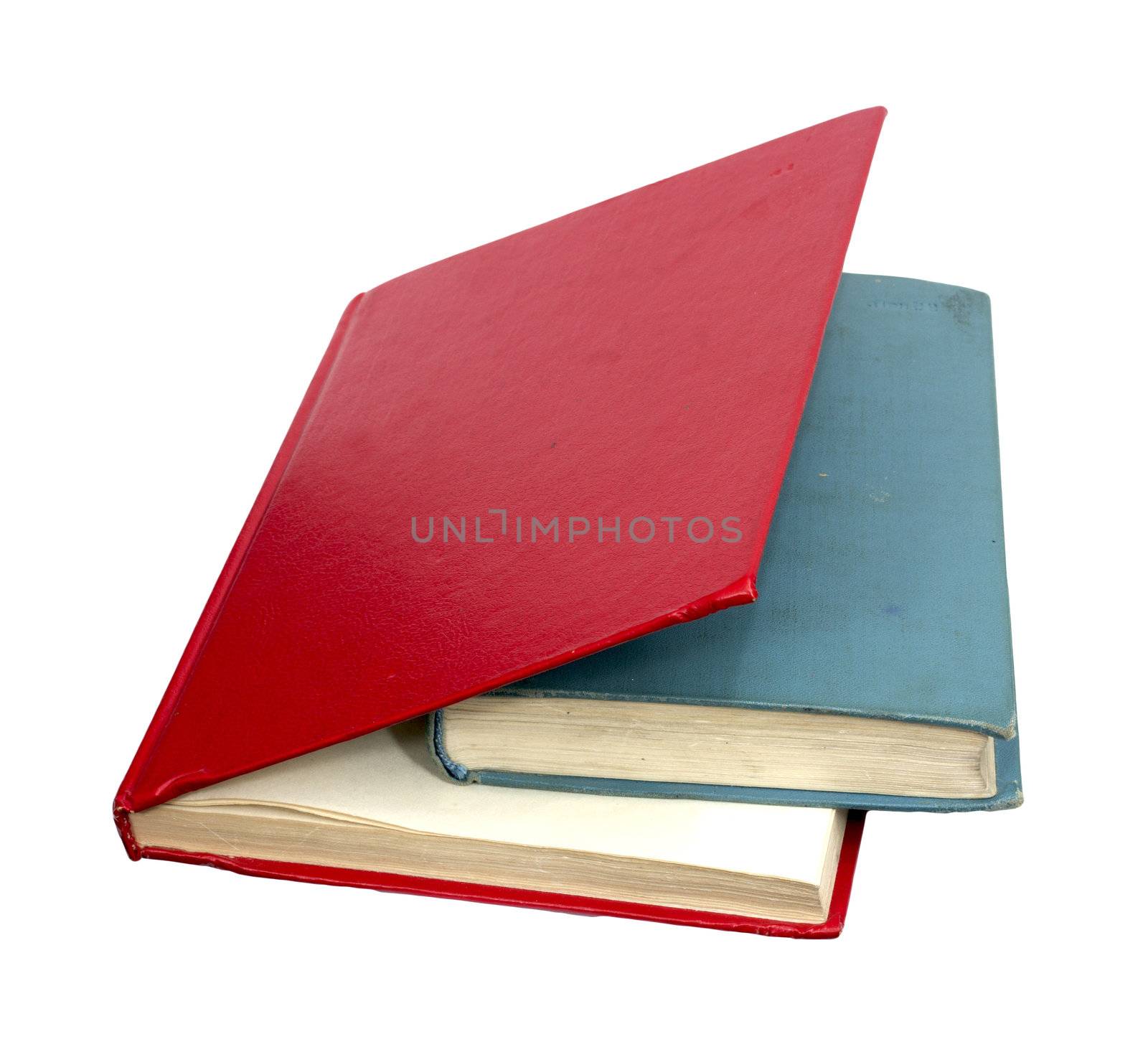 closed red and blue books on a reflecting white background  by schankz