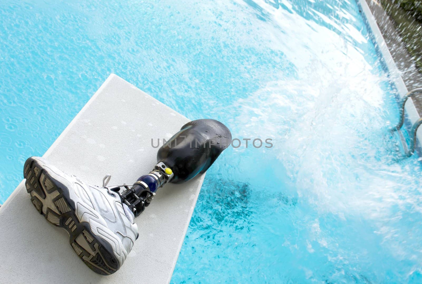 Cannonball splash in a pool with prosthetic leg left on diving board.