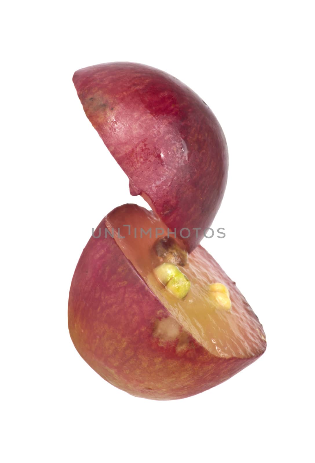 Translucent slice of red grape fruit, macro isolated on white 