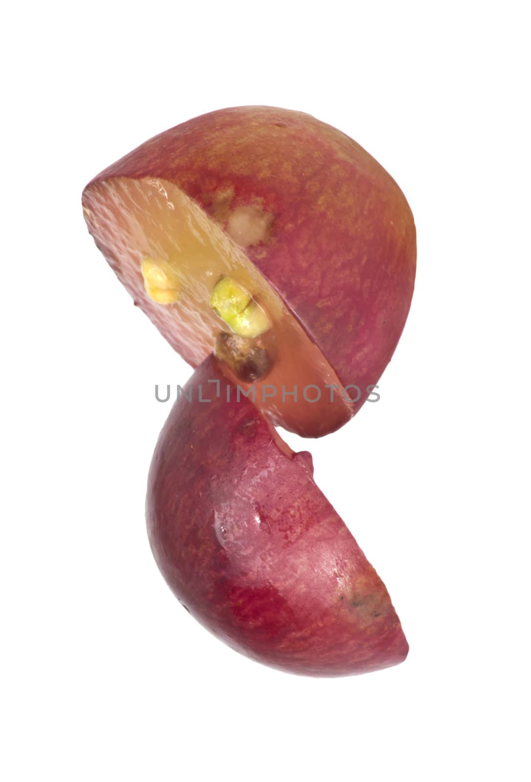 Translucent slice of red grape fruit, macro isolated on white 