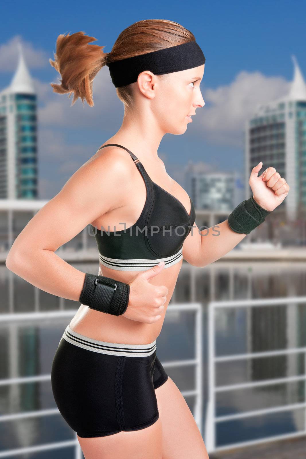 Young fit woman jogging in a modern city