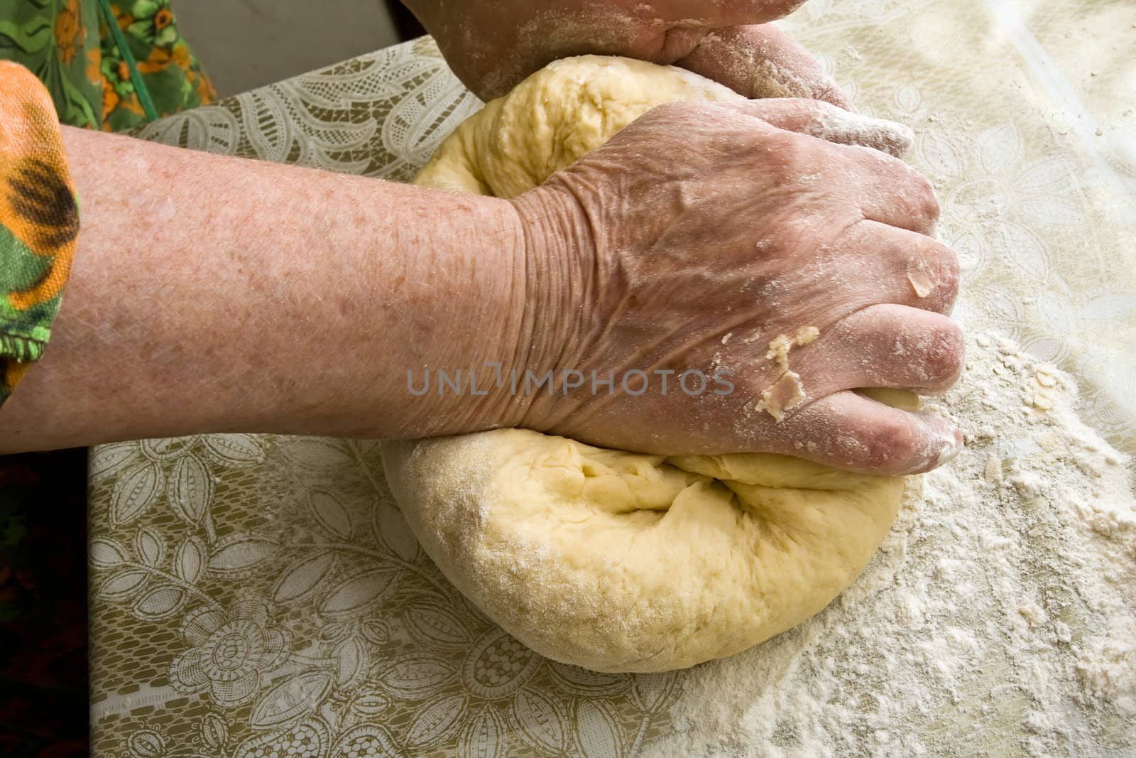 Hands of old woman making dough