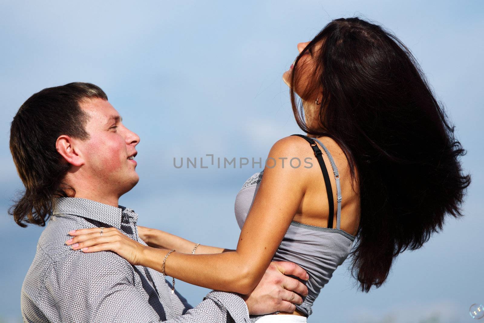 man and woman hug in the sky