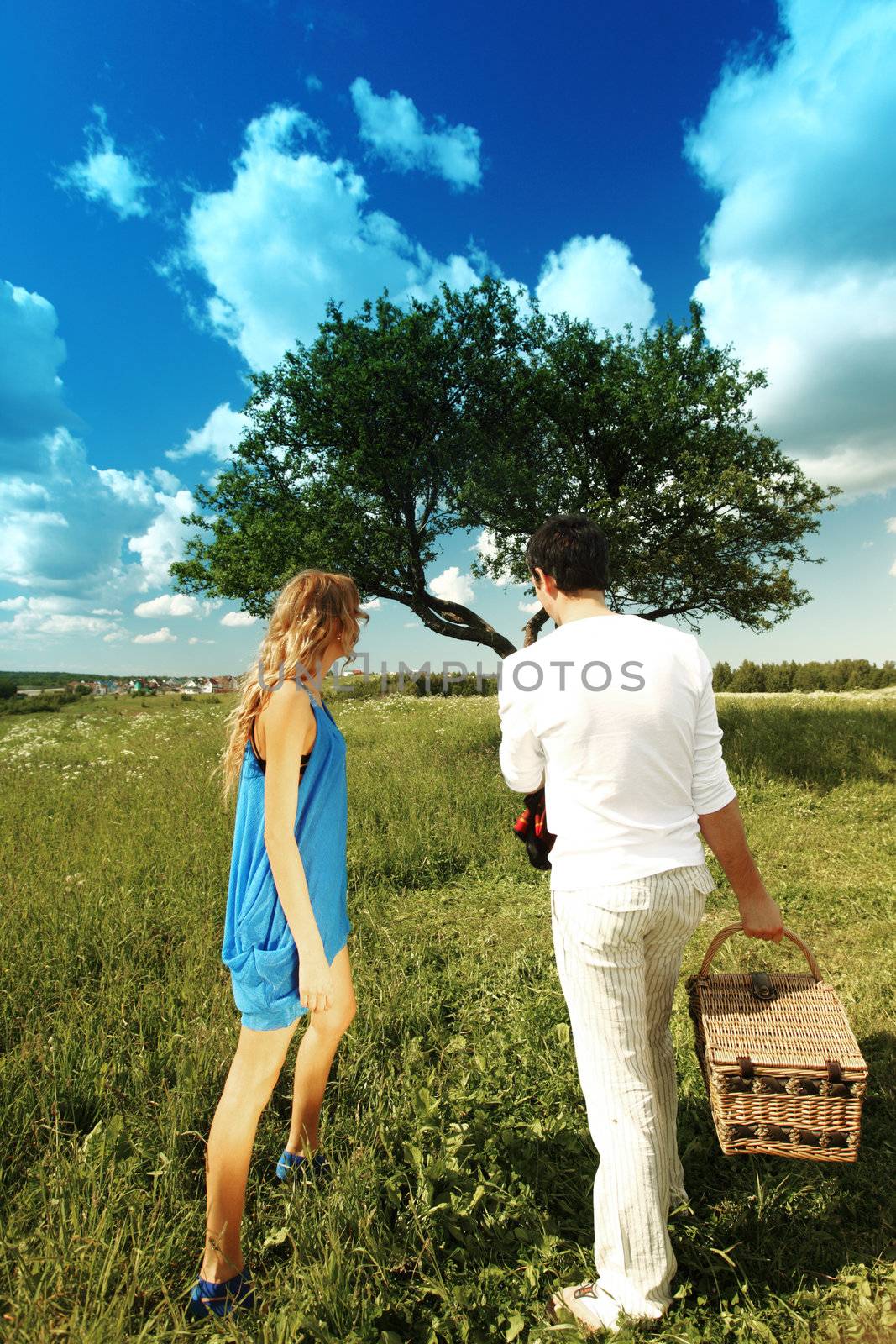 man and woman on picnic in green grass