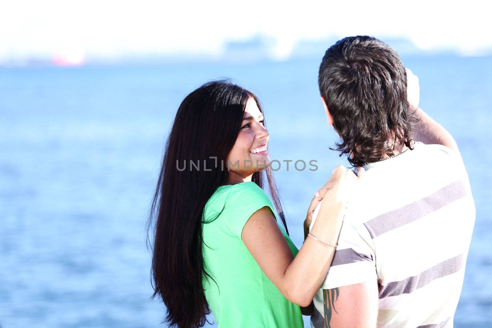 man and woman hug in the sky sea on background