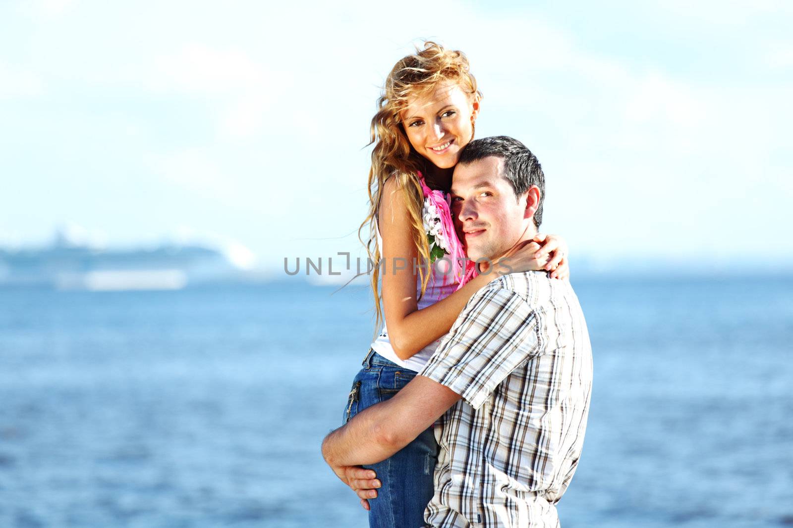 man and woman hug in the sky and sea on sea