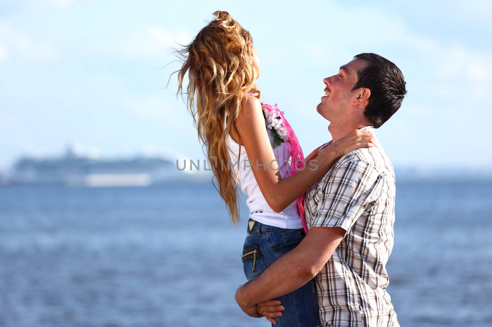 man and woman hug in the sky and sea on sea