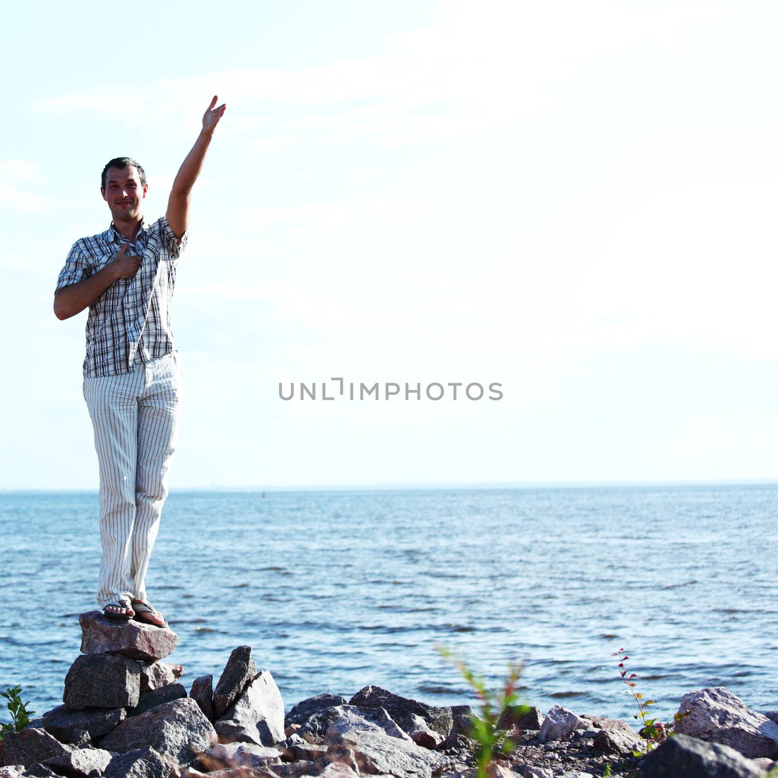 man stay on ground sea on background