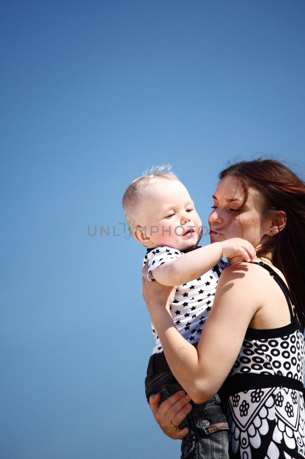 happy mother and son in blue sky