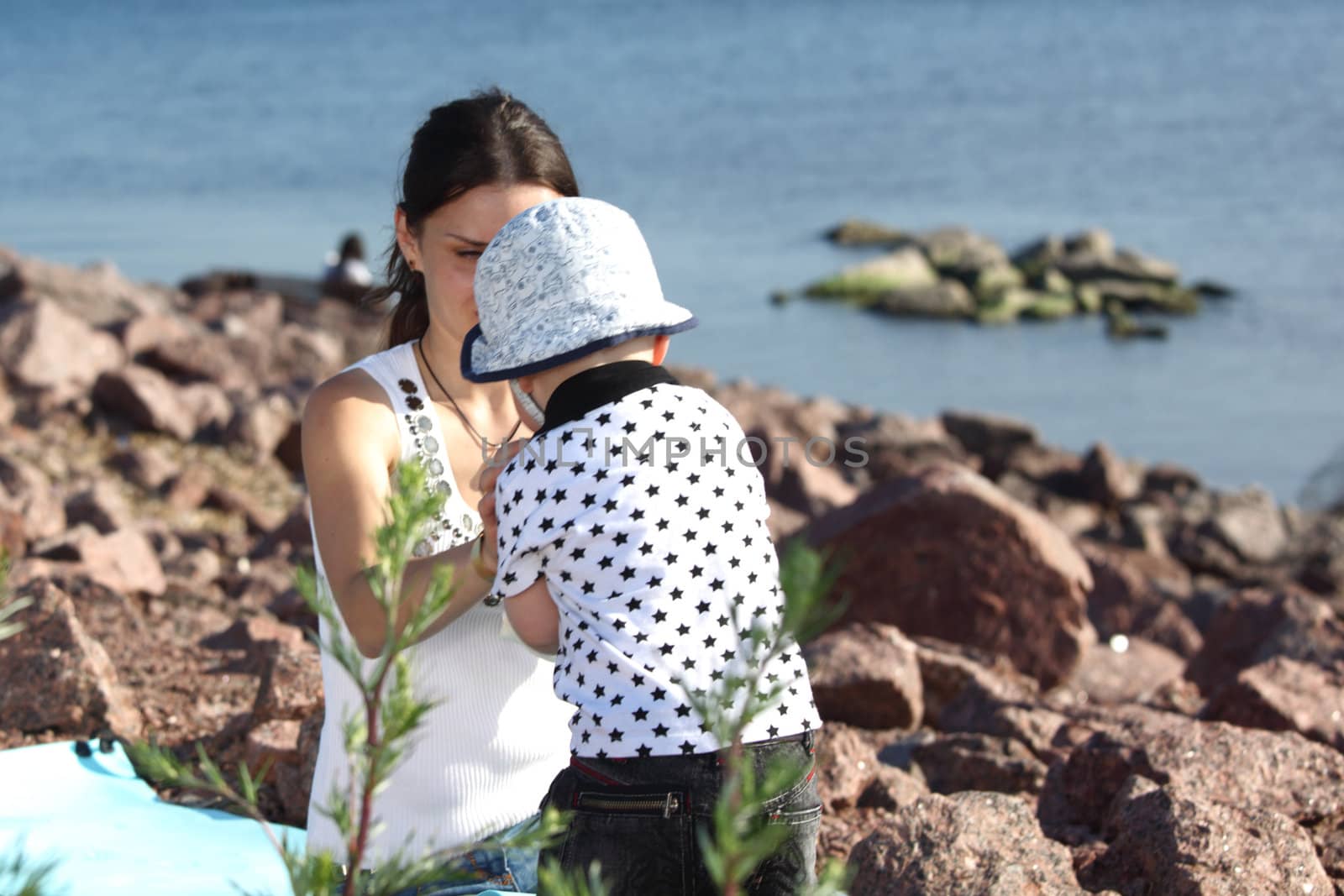 happy mother and son on picnic near sea