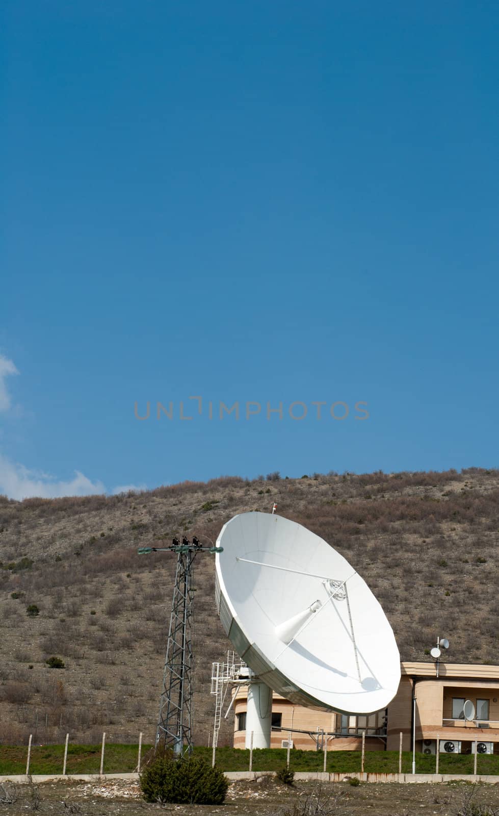 Telecommunications dish emitting signals in the ether