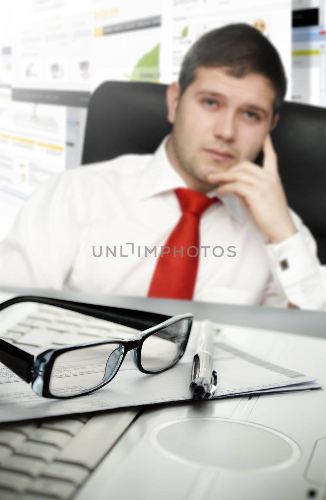 Young businessman at office with selective focus on glasses and pen-NOTE:All webpages used for this collage are created by me.You can see some of the photos used in my galery